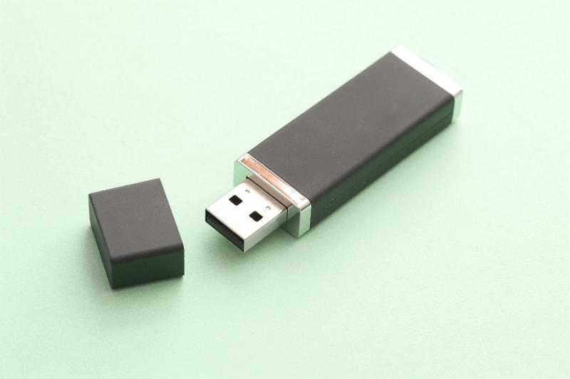 Free Stock Photo: Open USB flash storage drive for a computer on a green background with copy space in a communications concept