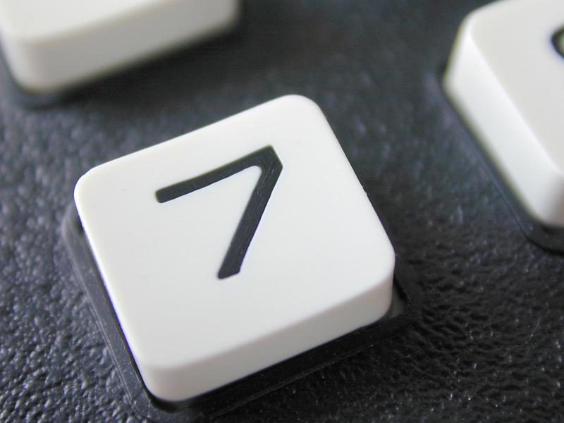 Free Stock Photo: Lucky number 7 key on a white button on the keypad of a retro mobile phone with buttons in a close up view