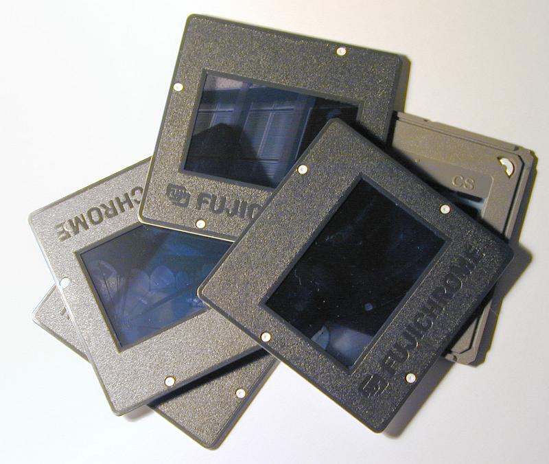 Free Stock Photo: Pile of old 35mm film slides in plastic mounts viewed from above on white in a photography concept - editorial use only