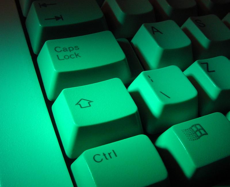 Free Stock Photo: Shift and control keys on a white computer keyboard illuminated by a green light in a close up background view