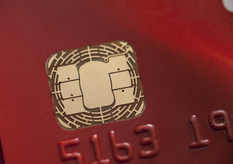 Free Stock Photo: Macro view of the smart chip on a red bank credit card for identification and authentication of transactions for payment