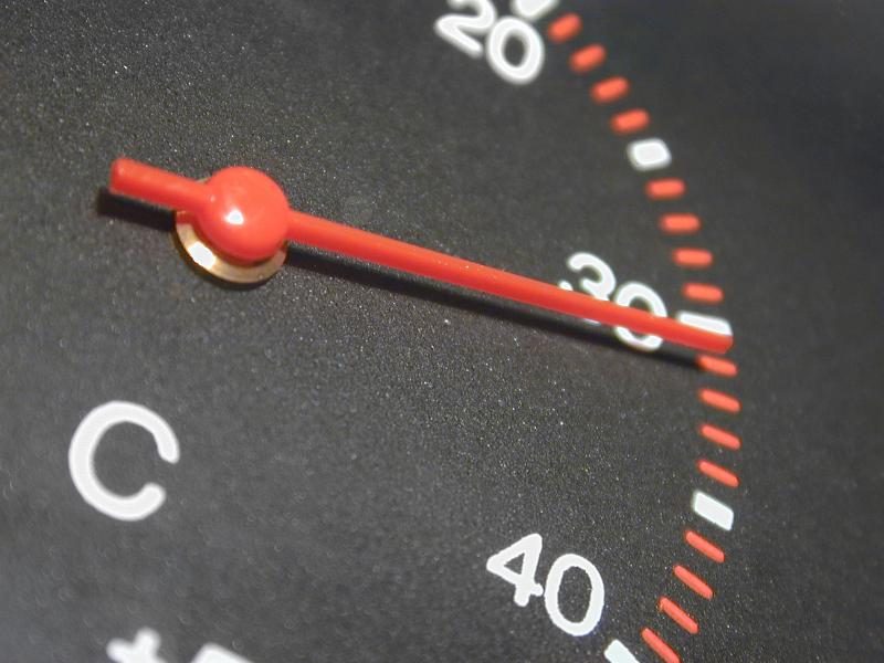Free Stock Photo: Circular temperature gauge and dial with a red needle pointing to 30 degrees Celsius