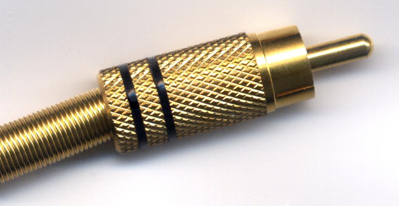 Free Stock Photo: Gold colored connector jack plug on studio background