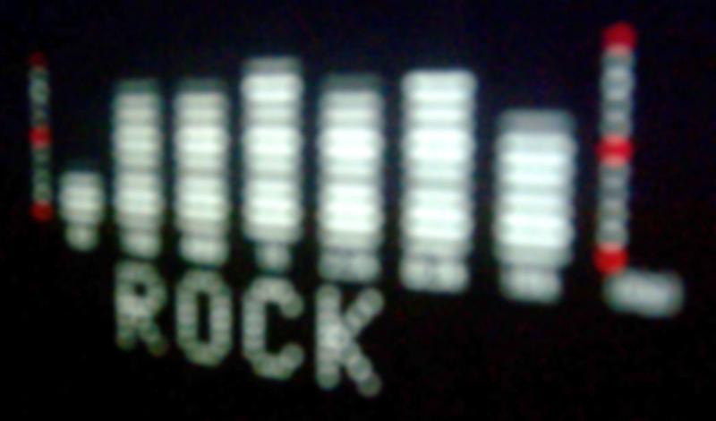 Free Stock Photo: A digital VFD display showing a music audio spectrum and equiliser preset setting of ROCK