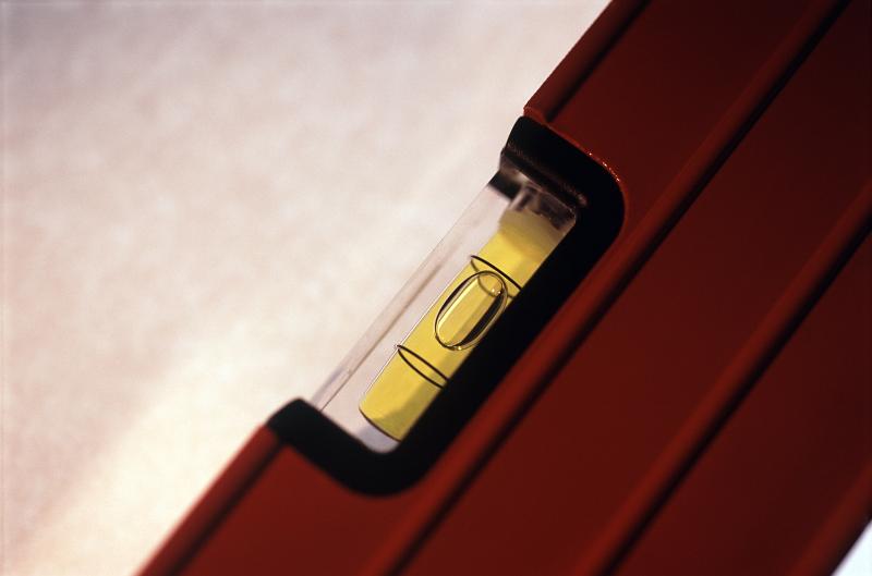 Free Stock Photo: Red spirit level or bubble level viewed diagonally in close-up with copy space