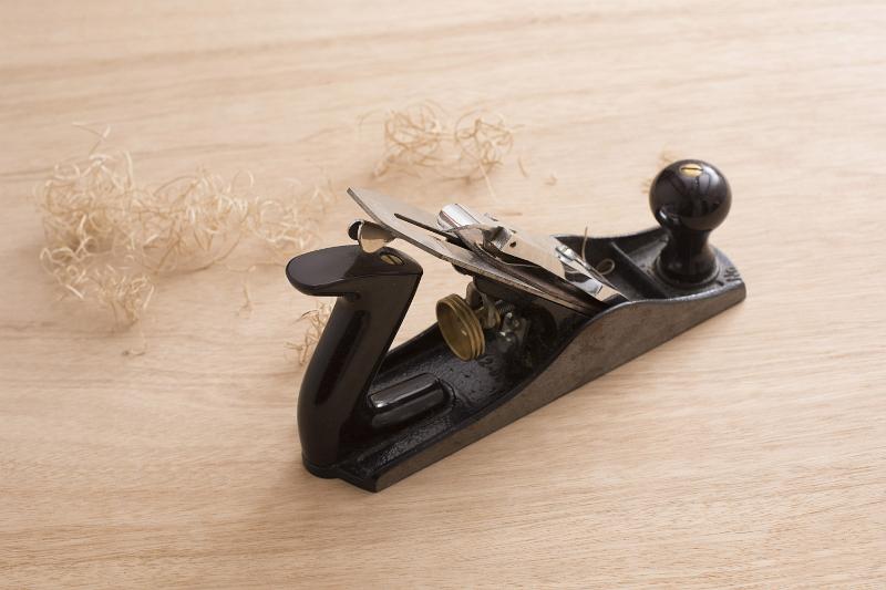 Free Stock Photo: Carpenters plane tool and shavings on wooden surface viewed from high angle