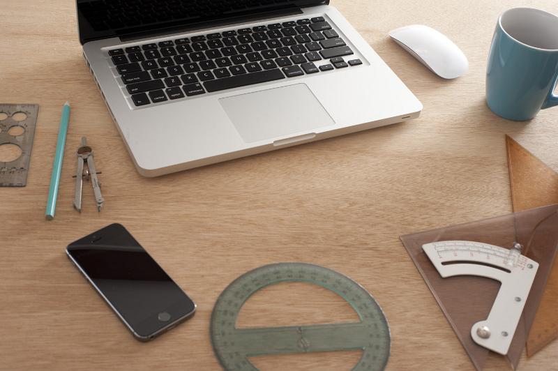 Free Stock Photo: Workstation of an engineering draughts person with laptop computer and precision instruments for measuring alongside a mobile phone and coffee