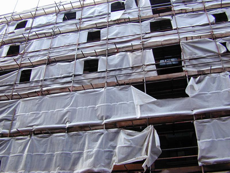 Free Stock Photo: Scaffolding and plastic covers at a building site in a concept of commercial development and construction of high rise buildings