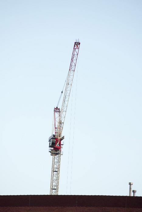 Free Stock Photo: Top of a construction crane colored white and red viewed from low angle against clear blue sky