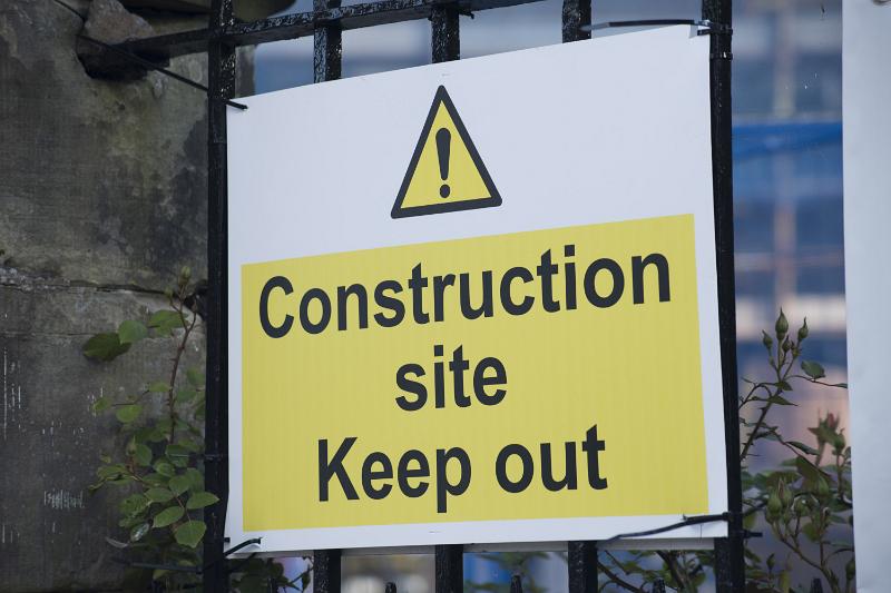 Free Stock Photo: Construction Site yellow sign outdoors, with explanation mark warning to keep out, viewed in close-up