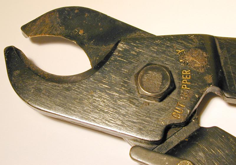 Free Stock Photo: Old cutters for copper wires with engraved notice - cut copper only. Viewed in close-up on white surface