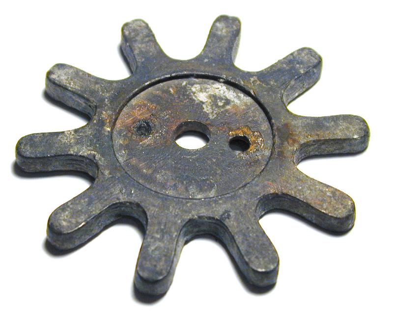 Free Stock Photo: Old corroded vintage toothed gear wheel on a white background viewed high angle