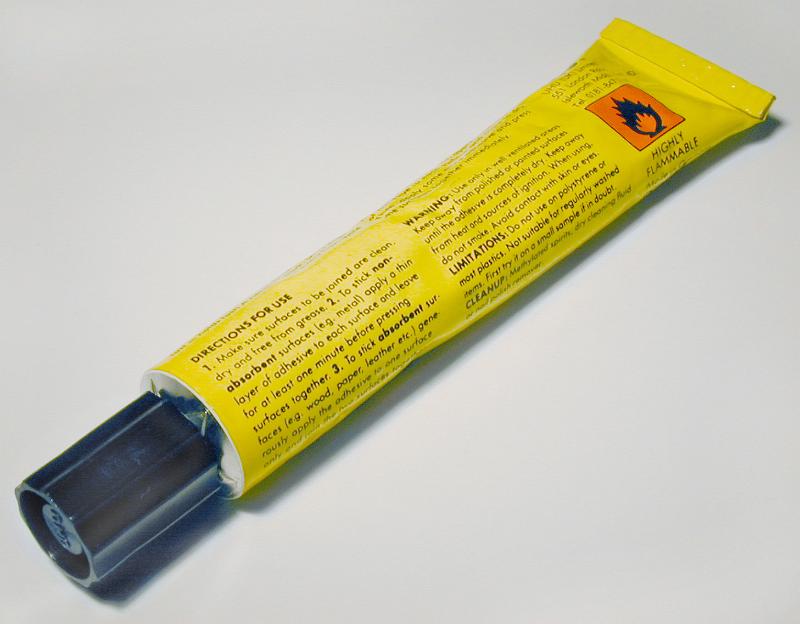 Free Stock Photo: Closed full tube of an universal glue, viewed diagonally in the frame in close-up on white background