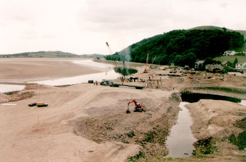 Free Stock Photo: bypass construction site with excavators and cranes working on building a bridge. Viewed from high angle from a drone