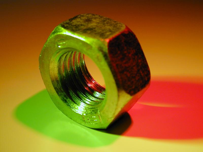 Free Stock Photo: The steel nut in macro close-up with colorful shadow of green and red colors
