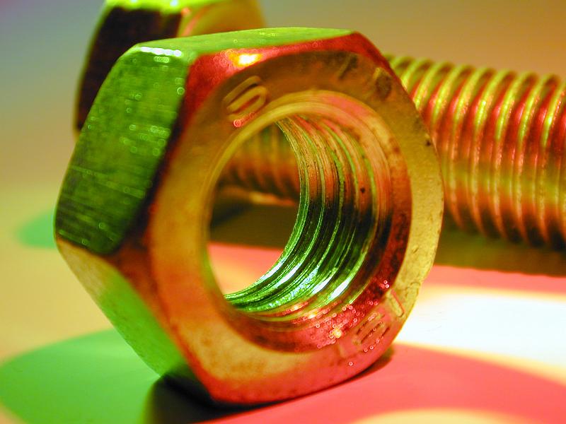 Free Stock Photo: Nut and bolt in macro close-up, lit up with green and red colors. Engineering background concept