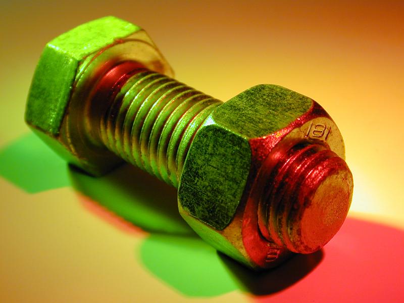 Free Stock Photo: Bolt with a nut in close-up lit up with colorful green and red lights