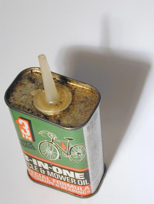 Free Stock Photo: Vintage oiler canister with oil for bicycles, viewed from high angle on white table