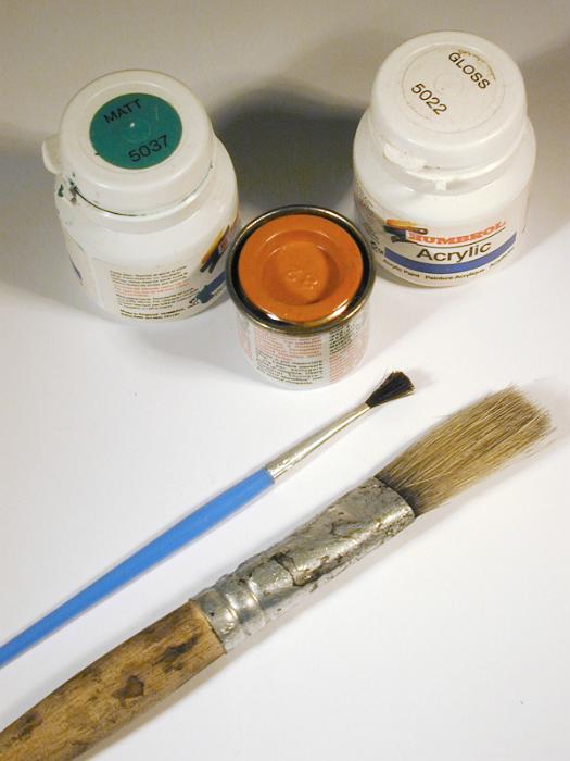 Free Stock Photo: Painting or decorating concept with paintbrushes of different sizes lying alongside small containers of paint viewed high angle