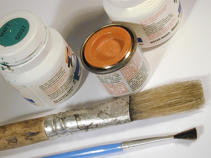 Free image of Small cans of paint and clean brushes