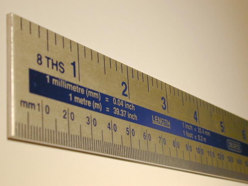 Free Stock Photo: Rule with metric and Imperial measurements with the scale marked in both centimetres and inches in a oblique receding view
