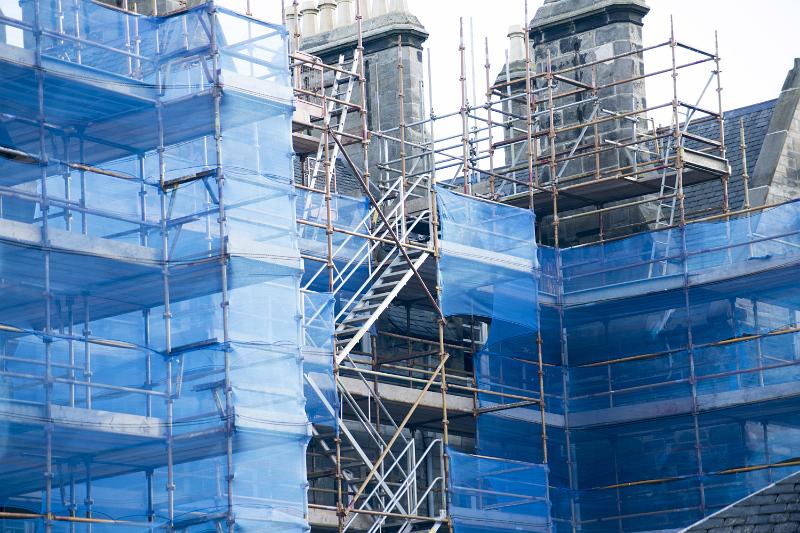 Free Stock Photo: Scaffolding and protective plastic on a high-rise building site during construction or repair in a close up view