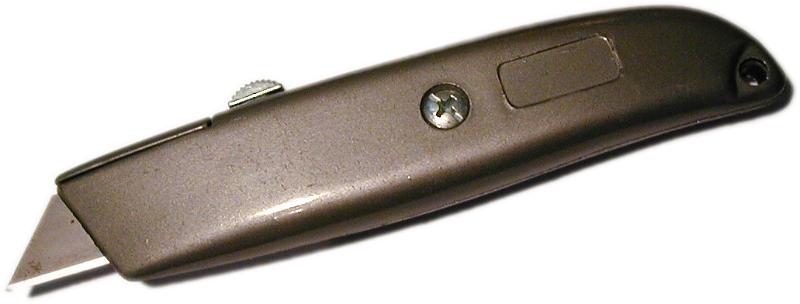 Free Stock Photo: Stanley knife with retractable blade in close up on white lying diagonally in a panorama banner