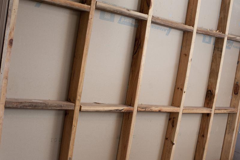 Free Stock Photo: Open stud wall of wooden frame house under construction, viewed in full frame from the side