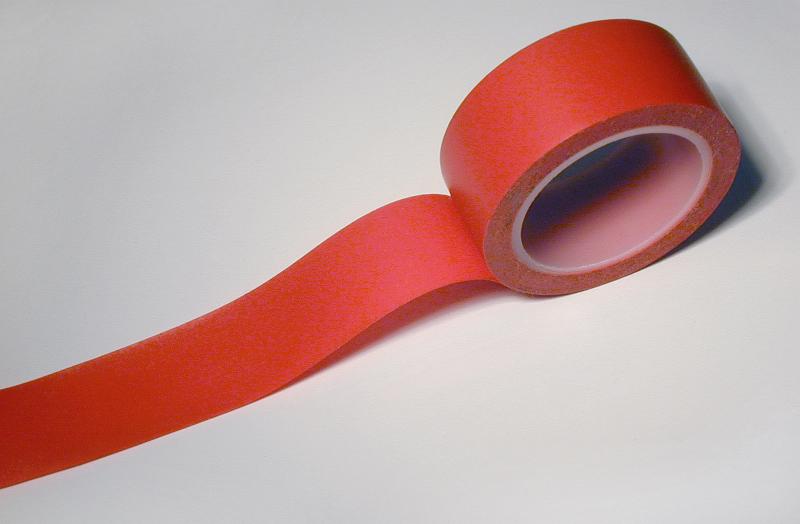 Free Stock Photo: Red insulating tape with unrolled end viewed in close-up on white background