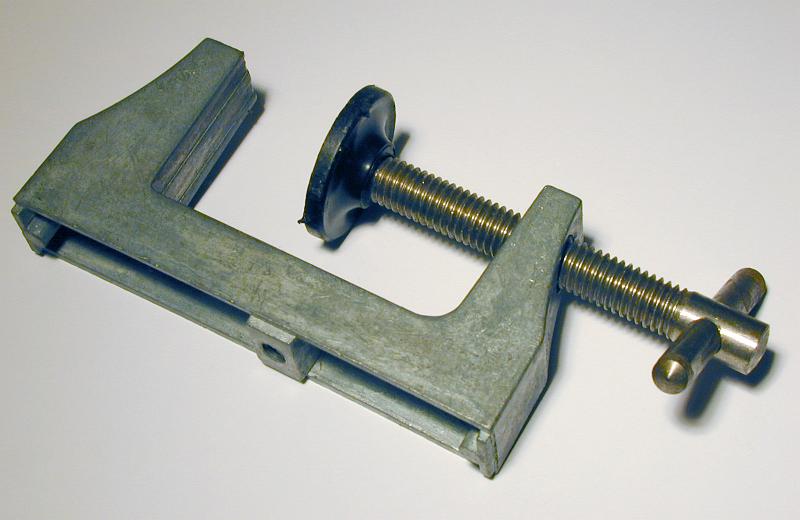 Free Stock Photo: The metal clamp with plastic press framed diagonally and viewed in close-up on white background