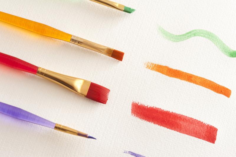 Free Stock Photo: Green, orange, red and purple watercolor paint strokes from different sized brushes over white textured canvas paper