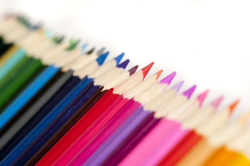 Free Stock Photo: Oblique close up of colored pencils of various shades aligned with copy space on white
