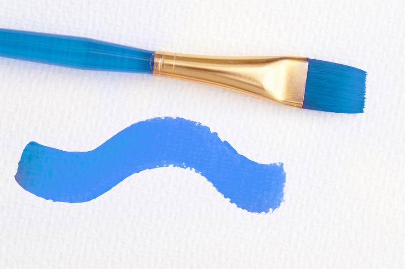 Free Stock Photo: Blue paintbrush with a painted wavy line of blue paint on a textured white paper in a concept of art and creativity