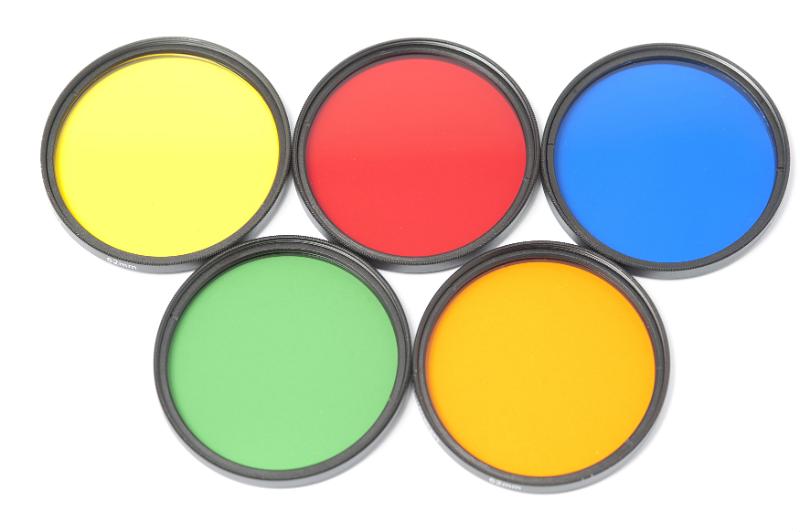 Free Stock Photo: Set of round colored glass photographic filters in yellow, red, blue, green, and orange isolated on white