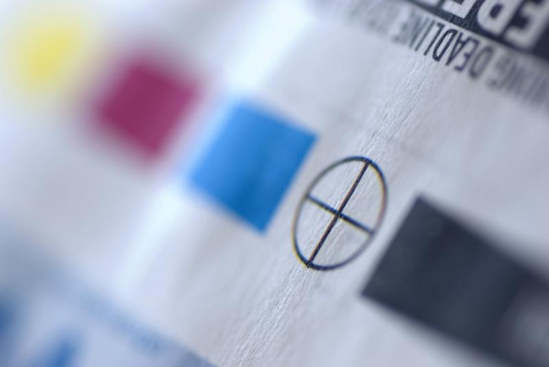Free Stock Photo: Extreme close up of offset press registration marks with alignment, black, cyan, magenta and yellow plate colors