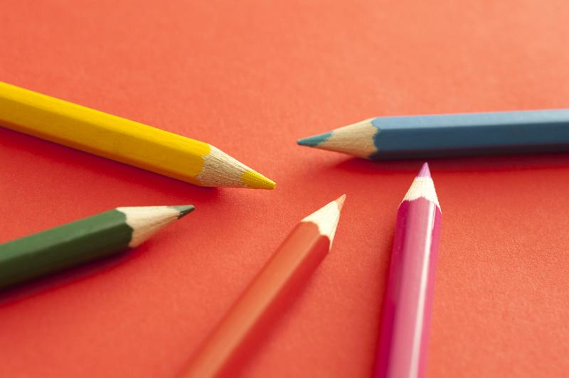 Free Stock Photo: Close up of five colored pencils, yellow, red, pink, blue and green, over orange background