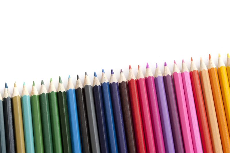 Free Stock Photo: Slanted row of new sharpened colored pencils in green, blue, red, pink and orange with copy space over white