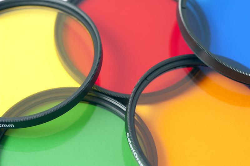 Free Stock Photo: Five colorful photographic filters in red, blue, yellow, orange and green viewed close up and overlapping in a full frame background
