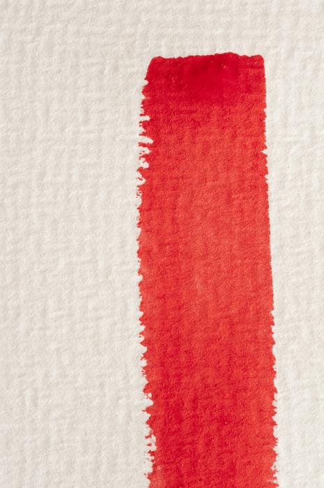 Free Stock Photo: Single vertical red watercolor paint brushstroke on a textured white paper with copy space in a conceptual image of art and creativity