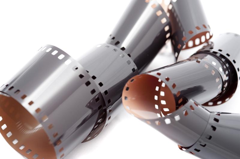 Free Stock Photo: Tangled messy rolls of unprocessed and exposed 35 mm film wrapped up over white background