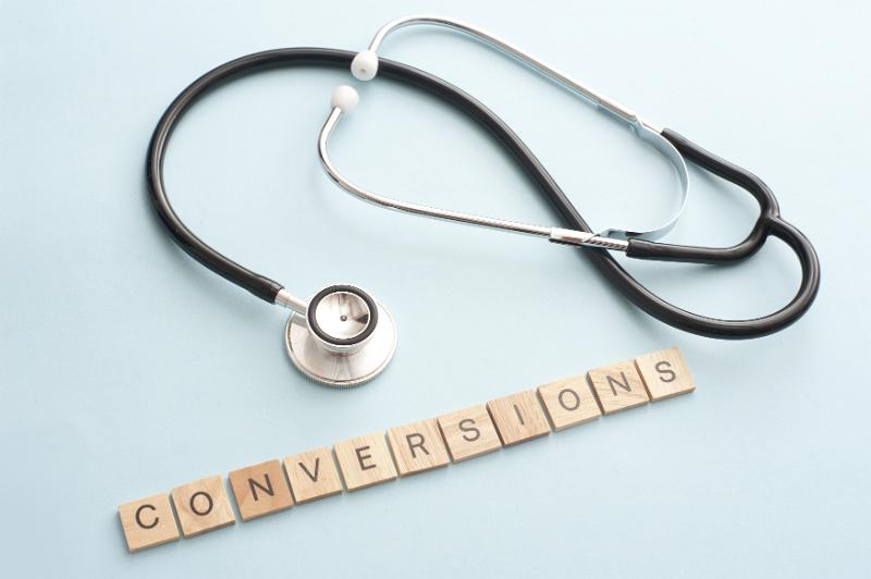 Free Stock Photo: knowledge and conversions in website analysis concept with doctor stethoscope and square piece letters spelling the word conversions