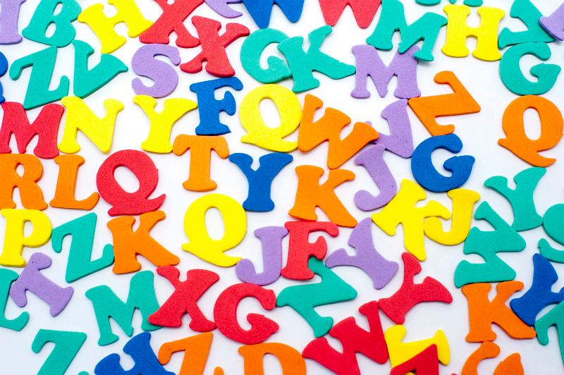 Free Stock Photo: Brightly coloured scattered consonants inan education and learning background for teaching young preschoolers their alphabet