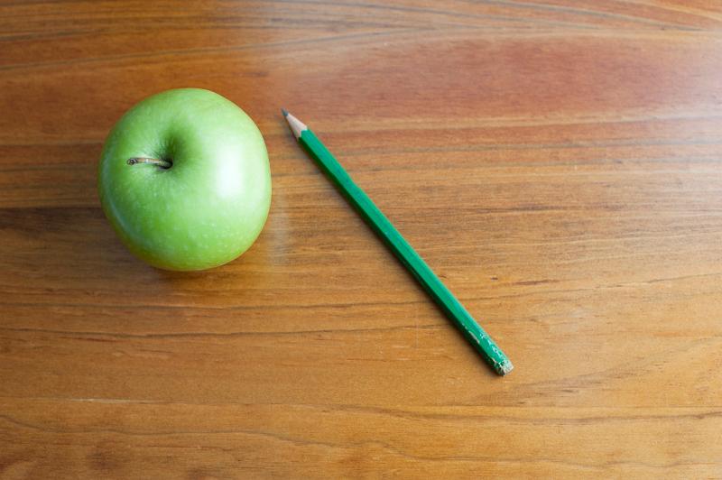 Download image of Apple on a school desk Free Stock Photo: education background, an apple on a wooden school desk