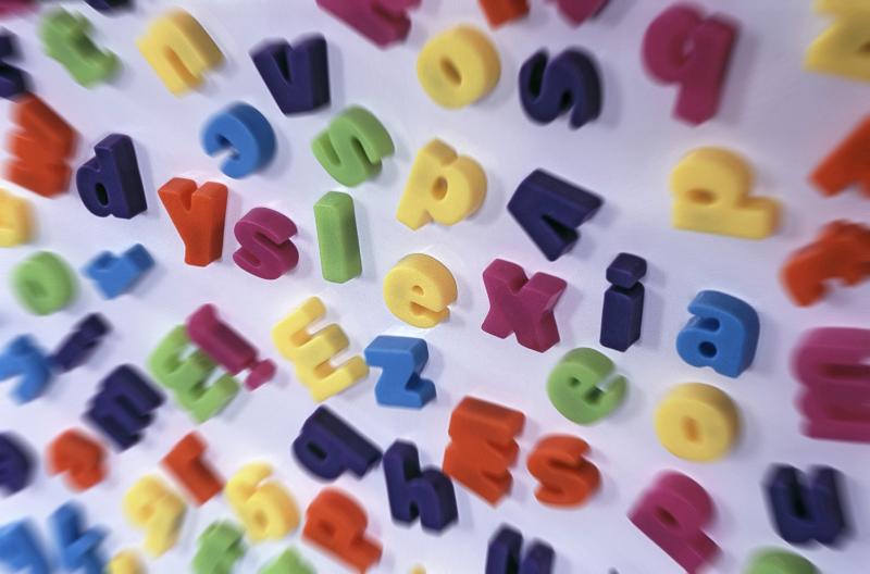 Free Stock Photo: Jumbled blurred lettering as seen by a person suffering from dyslexia with the word DYSLEXIA scattered through the centre in a conceptual image of this medical disability