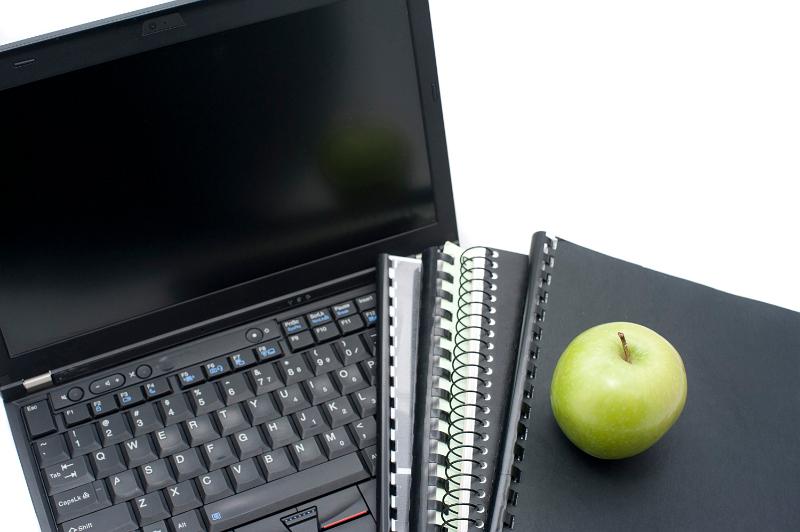 Free Stock Photo: Study concept closeup of an open laptop, with workbooks and notebooks and a fresh green apple