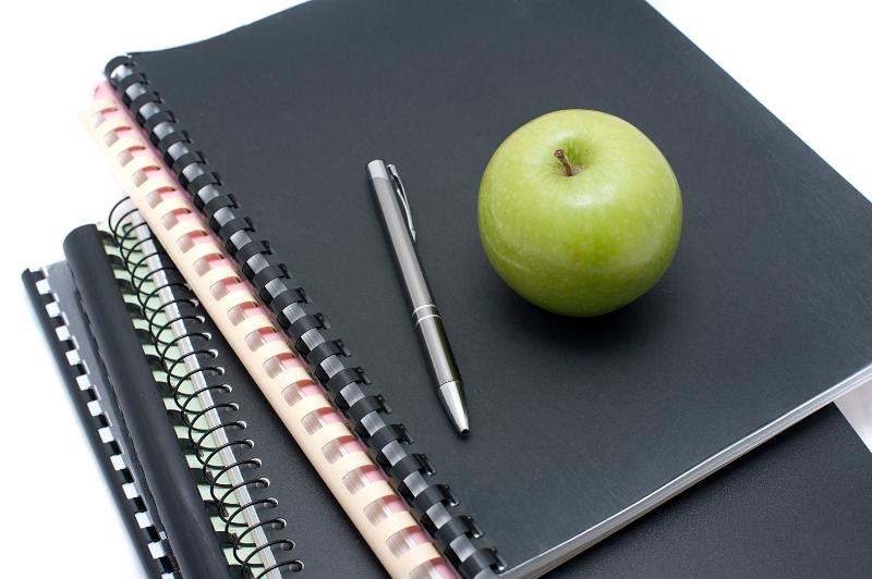 Free Stock Photo: Black notebook binders piled, apple on top, concept of university of college education