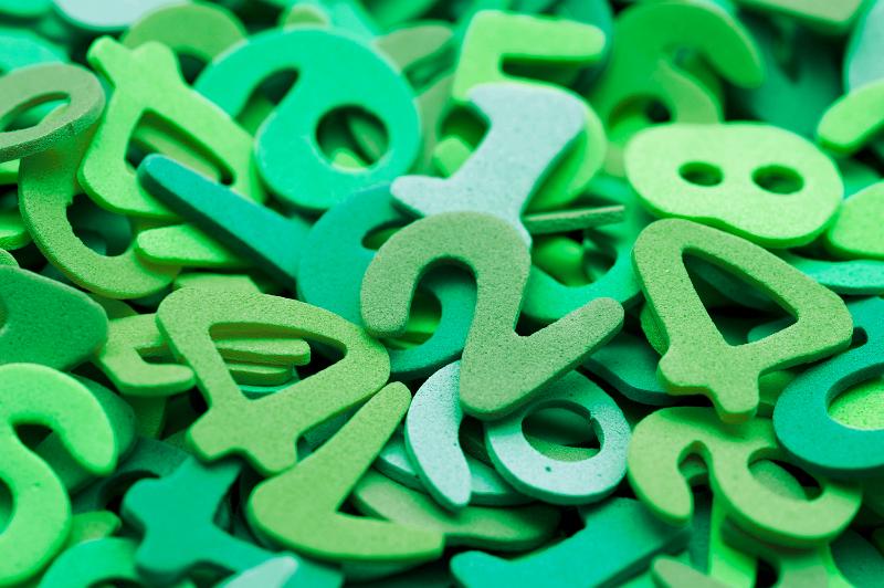 Free Stock Photo: Random pile of green plastic numbers for use in a kindergarten or preschool to teach young children to count and do basic maths