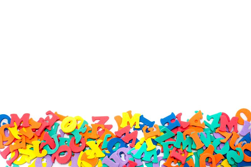 Free Stock Photo: Alphabet letter border with colourful plastic letters in a random jumble isolated against white copyspace for your education or communication concept