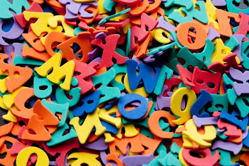 Free Stock Photo: Random pile of mulitcoloured plastic alphabet letters for use in a kindergarten or preschool to teach young children basic language skills and to read, spell and write