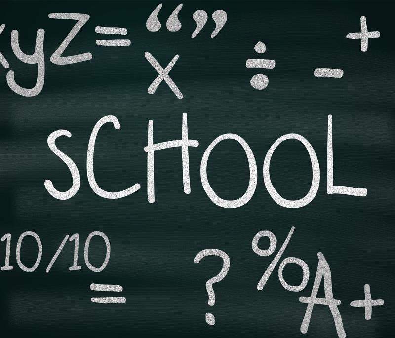 Free Stock Photo: School blackboard with random handdrawn chalk education symbols and the word SCHOOL in the centre in a teaching and learning concept